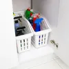 Cleaning supplies stored in white plastic baskets inside a cabinet. Produktbild-Vorschau