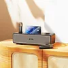 A black Hoco BS63 Bluetooth speaker with two microphones and a smartphone docked on top, placed on a wooden cabinet. Podgląd zdjęcia produktu
