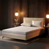 A mattress on a bed frame in a bedroom setting with ambient lighting. Produktbild-Vorschau