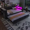 A modern bedroom or living room with a dark gray daybed and pull-out trundle bed, featuring built-in shelving and pink LED lighting. Náhľad obrázku produktu