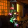 A solar-powered wind chime with multiple hummingbird figures hanging from a central unit, illuminated by colorful LEDs. Voir les images du produit
