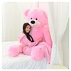 A young woman is sitting on a bed, hugging a large pink teddy bear. Anteprima dell’immagine prodotto