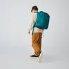 A person wearing a backpack and walking. Podgląd zdjęcia produktu