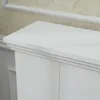 A close-up view of the top edge of a white fireplace surround. Produktbild-Vorschau