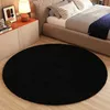A bedroom scene with a bed, nightstand, and a round rug. Voir les images du produit
