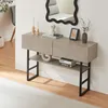 A console table with two drawers and a shelf, decorated with various items, placed against a wall. Anteprima dell’immagine prodotto