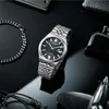 A watch and accessories are arranged on a black reflective surface. Anteprima dell’immagine prodotto