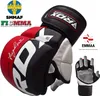 A pair of RDX MMA gloves with various logos and text. Voir les images du produit