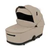 A beige and black baby stroller bassinet is shown against a white background. Voir les images du produit