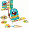 A toy game set featuring a blue monster and food pieces. Podgląd zdjęcia produktu
