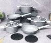 A set of cookware arranged on a textured gray surface. Podgląd zdjęcia produktu