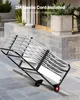 A metal chair cart with chairs folded and stacked on it, resting on a stone patio. Anteprima dell’immagine prodotto