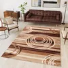 A living room scene with a sofa, armchair, side table, and a rug. Produktbild-Vorschau