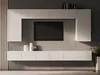 A modern white media console with a television mounted above it, set against a dark gray wall. Náhled obrázku produktu