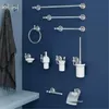 A collection of chrome bathroom accessories mounted on a dark blue wall. Anteprima dell’immagine prodotto