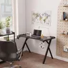 A gaming desk setup in a room with a window and a pegboard wall. Voir les images du produit