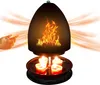 A hand is shown reaching towards a candle-powered heater that displays a flame effect. Produktbild-Vorschau