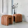 Two orange fabric stools are placed in a modern interior with concrete walls and a window. Anteprima dell’immagine prodotto