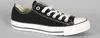 A black Converse All Star shoe is shown against a plain gray background. Voir les images du produit