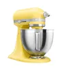 A yellow KitchenAid stand mixer with a silver bowl is shown against a white background. Produktbild-Vorschau