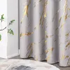 A close-up of a gray curtain with a gold marble pattern, next to a white wall and a plant. Produktbild-Vorschau