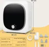 A white mini washing machine with a black front panel and a silver dial is shown with dimensions and specifications laid out. Náhľad obrázku produktu