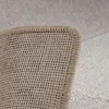 A close-up view of the underside and edge of a rug, showing its woven backing and binding. Produktbild-Vorschau