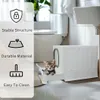 A kitten is peeking out of a white litter box in a bathroom setting, with text overlays highlighting product features. Podgląd zdjęcia produktu