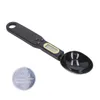A black digital measuring spoon and a coin battery on a white background. Náhľad obrázku produktu