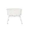 A white baby bassinet on a white stand with wheels, isolated on a white background. Anteprima dell’immagine prodotto