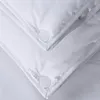 Close-up view of white fabric with visible buttons. Produktbild-Vorschau