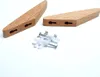 Two wooden hooks and screws with wall plugs on a white background. Produktbild-Vorschau