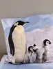 A pillow with a printed image of penguins in a snowy landscape. Náhľad obrázku produktu