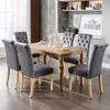 A dining room set with a wooden table and six upholstered chairs.