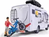 A toy camper van with a bicycle rack and a figure. Voir les images du produit