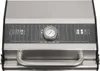 A close-up view of the top of a stainless steel table-top gas grill, showing the lid, a thermometer, and a handle. Produktbild-Vorschau