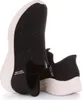 A pair of black Skechers Slip-Ins sneakers with pink soles, shown from a side-angle. Náhľad obrázku produktu