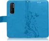 A blue flip case for a smartphone, open to show the inside. Produktbild-Vorschau
