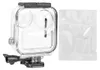 A clear plastic waterproof case for a GoPro MAX camera, with a mounting bracket attached, and a small white bag containing accessories next to it. Produktbild-Vorschau