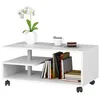 A white coffee table with storage shelves, books, a coffee cup, cake, and a potted orchid. Voir les images du produit