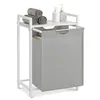 A laundry basket with a shelf on top, containing towels and soap dispensers. Produktbild-Vorschau