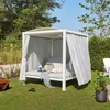 A white outdoor daybed with gray curtains and cushions, set up on a green lawn in a garden. Produktbild-Vorschau