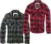 Two flannel shirts, one black and gray, the other red and black, are displayed side-by-side against a white background. Produktbild-Vorschau