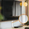 A television is mounted on a wall above a wooden cabinet, with a cable management channel running vertically along the wall. Náhled obrázku produktu