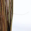 A close-up view of bundled willow branches tied together with wire. Produktbild-Vorschau