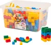 A clear plastic tub filled with colorful building blocks, with some examples of built structures shown below. Náhľad obrázku produktu