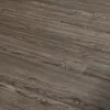A close-up, angled view of dark brown oak-patterned vinyl flooring. Produktbild-Vorschau