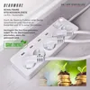 A white power strip with multiple plugs connected, set against a light gray and white background with a superimposed image of coins and plants. Produktbild-Vorschau
