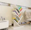 A modern living room with a white bookshelf filled with books, next to a white cabinet and a beige armchair. Náhľad obrázku produktu