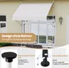 A white awning is installed above a glass door and window on a beige building. The lower part of the image shows close-ups of the awning's mounting components. Produktbild-Vorschau